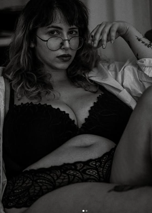 Lina vestita con una sexy lingerie nera. Questa immagine è in bianco e nero.